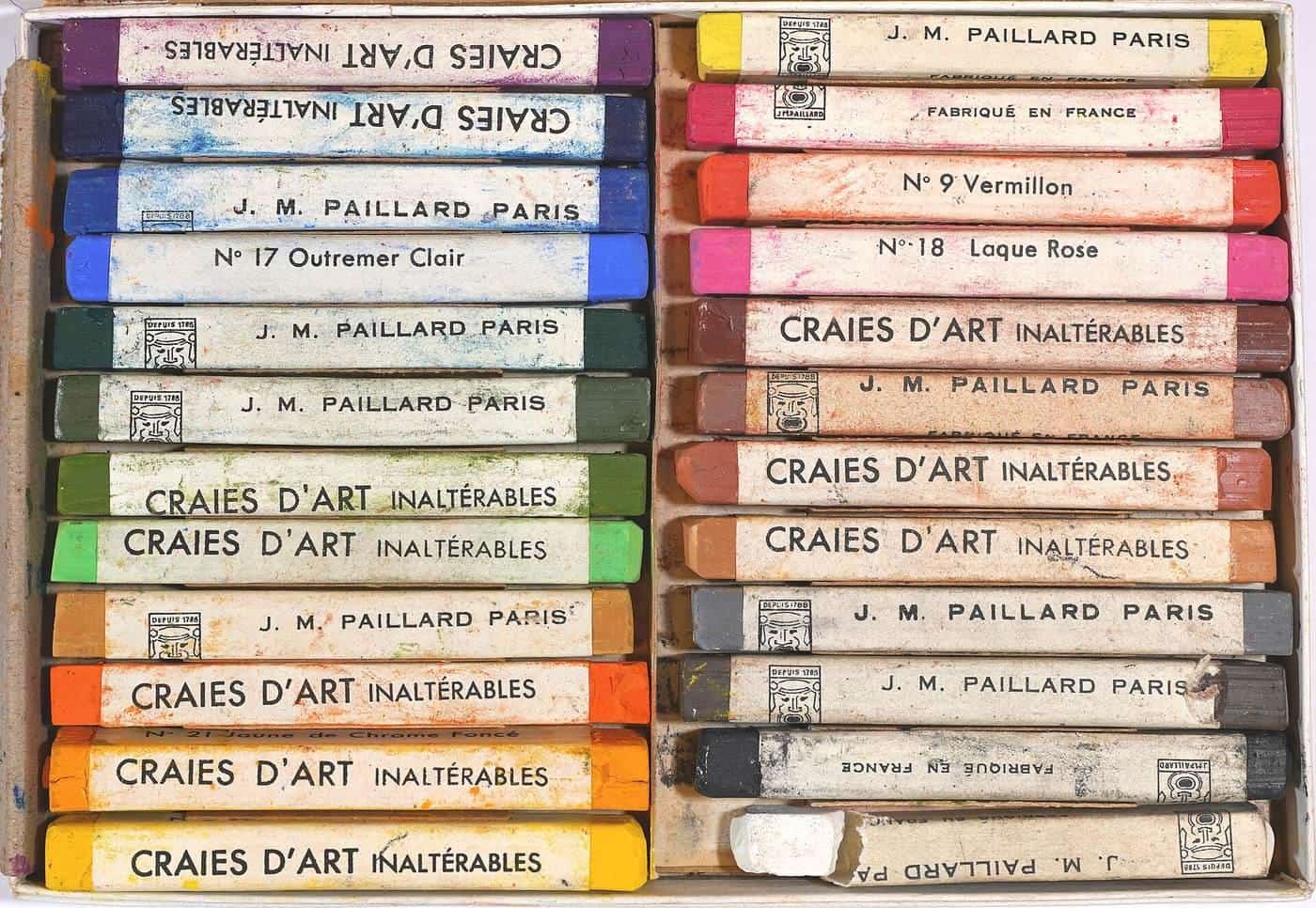 A box of soft pastel sticks in rows of colour